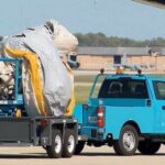 JUST IN: Workers Carry Away Emergency Slide From Air Force One After Deployment