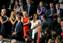 Tiffany Trump, Melania Trump, and Donald Trump Jr. among a crowd applauding at an event