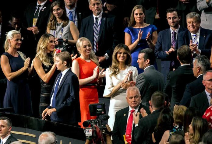 shutterstock_1041005722 Tiffany Trump, Melania Trump, and Donald Trump Jr. among a crowd applauding at an event