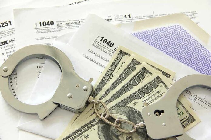 Handcuffs on tax forms with cash