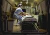 Nurse attending patient on stretcher inside ambulance