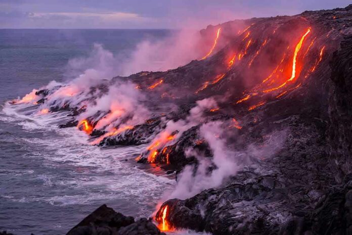 Lava flows entering the ocean along a rugged coastline