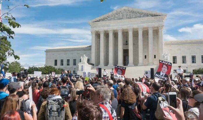 Crowd of protesters outside a neoclassical courthouse