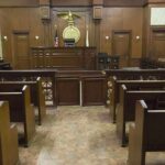 Man Who Killed a 5-Month-Old Baby in 1996 Set for Execution Interior view of an empty courtroom with wooden benches and a judges bench
