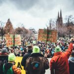 Brutal Teen Killing Caught On Snapchat Christian Jones at a large outdoor protest with crowds and handmade signs