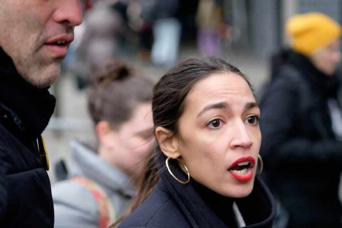 woman speaking outdoors with red lipstick and hoop earrings