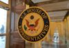 U.S. House of Representatives seal on a glass door