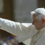 Pope waving to a crowd during a public appearance