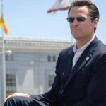 man in suit wearing sunglasses outdoors