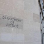 Department of Justice building exterior with American flags