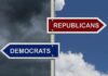 Directional signs for two political parties on a pole