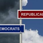 Directional signs for two political parties on a pole