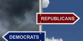 Directional signs for two political parties on a pole
