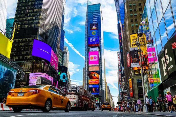 shutterstock_1689523810 Times Square street with yellow taxi and bright billboards