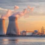 Energy Emergency: Marcos Flirts With Nukes Nuclear power plant with cooling towers emitting steam at sunset