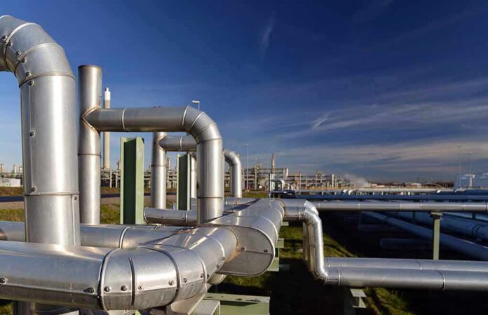 Industrial pipelines at a processing plant under blue sky