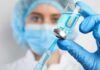 Birthright Baby Boom Under Federal Microscope Healthcare worker drawing blue liquid from vial with syringe