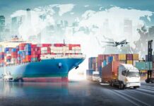 Cargo ship with containers alongside trucks, plane, and forklifts at a port