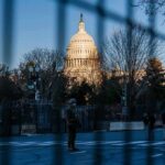 Evacuate Now: Feds Clear Trump Crowd U.S. Capitol behind security fencing and guards on a street