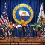 DOJ Cleared It—Now States Try A Veto Press microphones at a podium before California governor seal