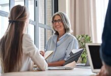 Nevada Court Nukes 40-Year Abortion Rule Smiling woman with gray hair talking in a modern office