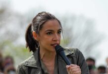 A Presidential Run Just Stayed On The Table AOC speaking into a handheld microphone outdoors