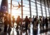 Airport Gridlock Explodes After Ash Blast Passengers queue inside an airport terminal at sunset