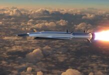 Hypersonic missile flying above clouds with bright exhaust flame