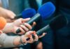 License Loopholes Kill — Senator Demands Answers Reporters holding colorful microphones