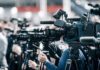 New King, Hard Limit — Constitution First Broadcast cameras on tripods at a press event