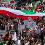 Hardliner Heir Rattles DC And Jerusalem Protest crowd with flags and signs; Seyed Ebrahim Raisi, La Parka, Brian Robiskie, Philly Brown, Miguel Francisco Barragán Andrade present