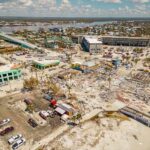 Shark Bite Chaos Near Florida Sandbar Aerial view of coastal town with widespread storm damage