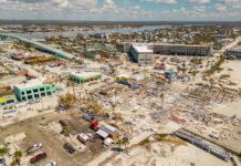 Shark Bite Chaos Near Florida Sandbar Aerial view of coastal town with widespread storm damage