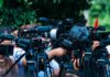 Air Force Stages Massive Stealth Display TV news cameras crowding together at an outdoor event