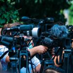 Newsroom Civil War Explodes at CBS TV news cameras crowding together at an outdoor event