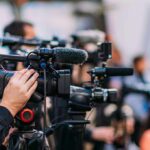Trump Renames A Great Lake — Chaos Ensues Video cameras on tripods at a media event