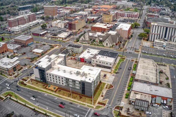 Aerial view of a downtown city block with streets and mixed-use buildings