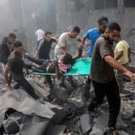 Children Crushed — Officials Scramble Rescuers carry an injured person on a stretcher through rubble