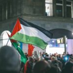 Palestinian flag waved at a nighttime street protest