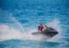 Florida Waters Flash—Dad Doesn’t Surface Man riding a jet ski across blue ocean water