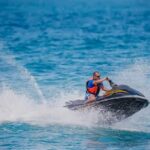 Florida Waters Flash—Dad Doesn’t Surface Man riding a jet ski across blue ocean water