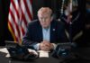 AI Fears Drive Surprise Manhattan Meet Donald Trump seated at a table between two desk phones