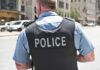 Police officer in uniform from behind on a city street