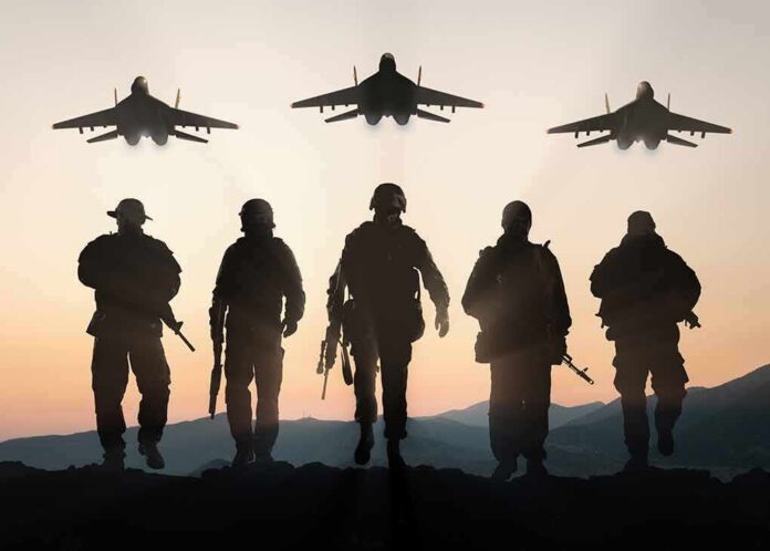 shutterstock_400783420 Soldiers walking with fighter jets flying overhead at sunset