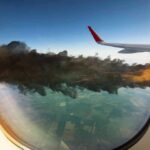Midair Horror Claim—Ryanair Stays Quiet Airplane wing seen through window with engine fire and smoke