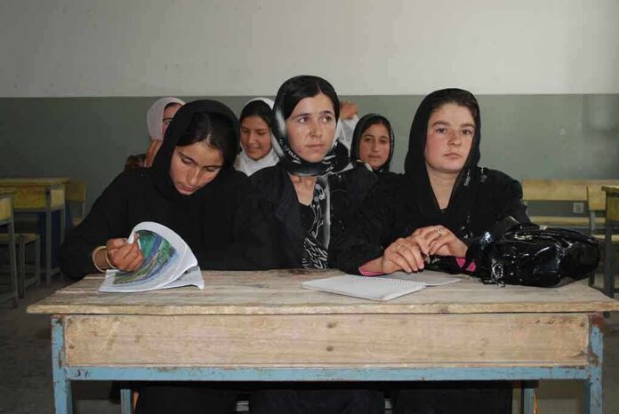 shutterstock_53407618 Sihem Habchi and other women seated at a classroom desk