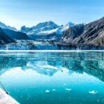 Quota Fight Stops Europe Cold Boat approaching a glacier in a turquoise fjord