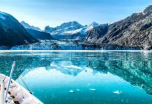 Quota Fight Stops Europe Cold Boat approaching a glacier in a turquoise fjord