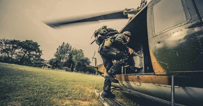 Soldier boarding a helicopter during field operation