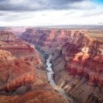 Phantom Ranch LOCKED DOWN After Sudden Deluge Grand Canyon with river winding through layered red cliffs